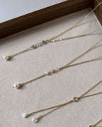 Gold filled lariat necklaces shown with labradorite and rose quartz drops, each finished with a freshwater pearl.