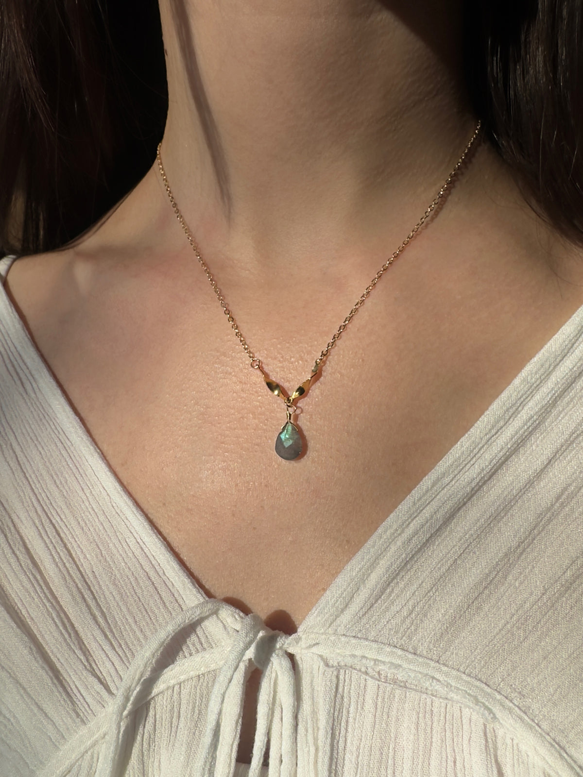 Gold filled labradorite drop necklace on a model.