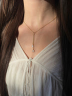 Gold filled rainbow moonstone lariat on a model, cascading moonstone teardrops on a fine chain.