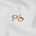 Gold vermeil Tiny Pearl huggie hoops with freshwater pearl drops on white silk.