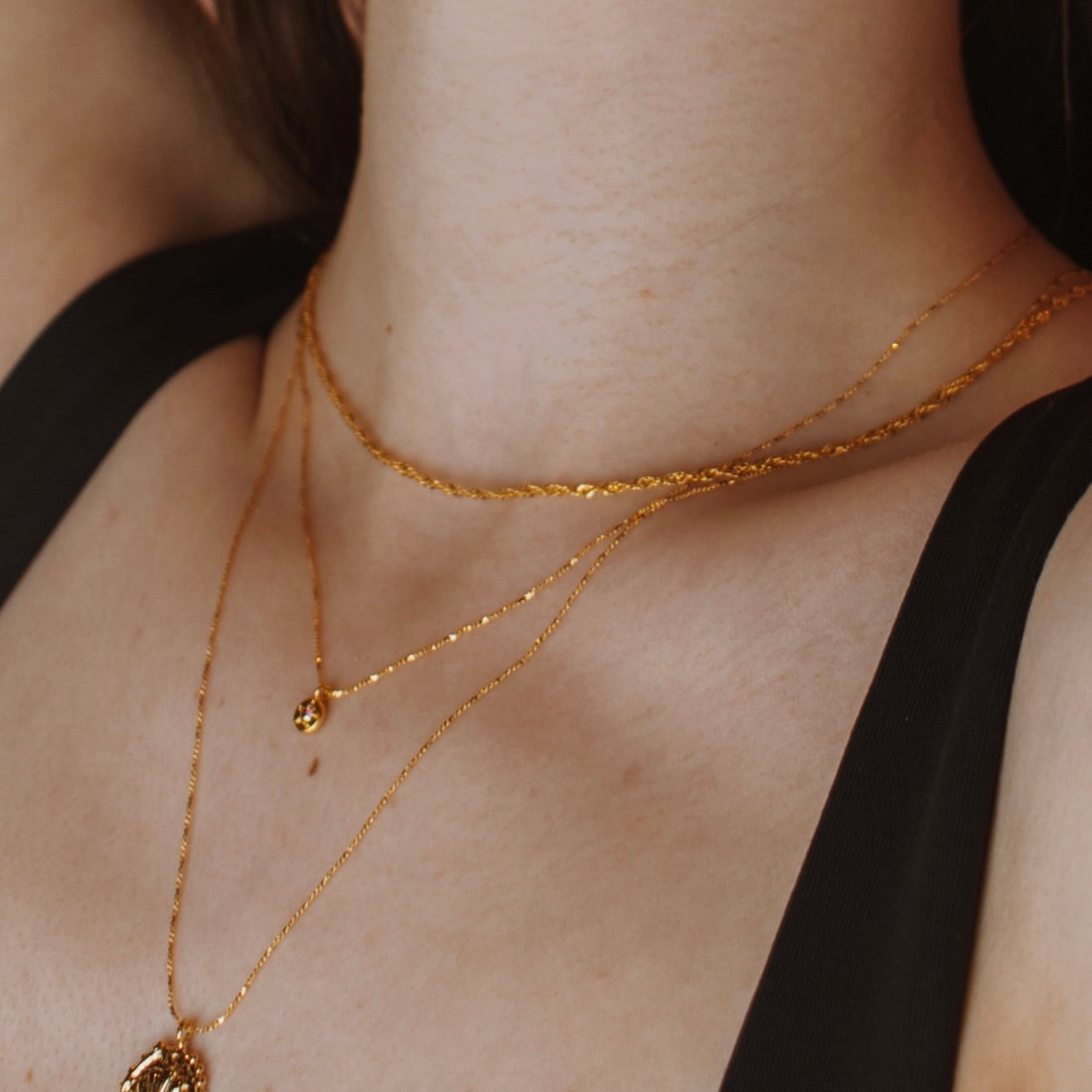 Gold filled Wave chain layered with a finer chain on a model.