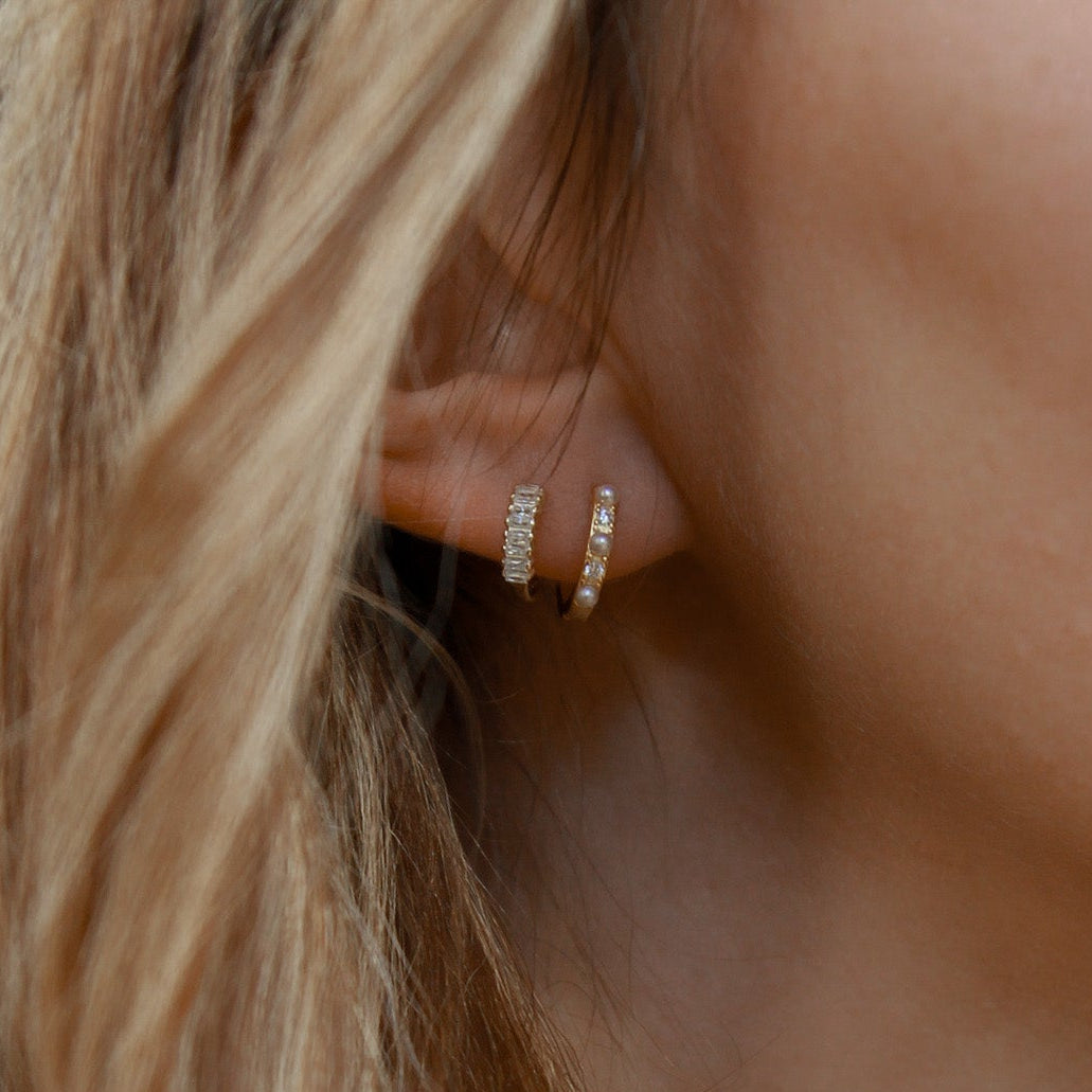 8mm huggie hoop earrings in 18K gold vermeil and 925 sterling silver featuring baguette cubic zirconia and pearl detail, hypoallergenic tarnish-resistant small snap closure hoops for sensitive ears.