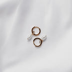 Gold vermeil Tiny Pearl huggie hoops with freshwater pearl drops.
