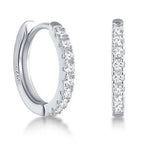 Pair of Tink huggie hoops in sterling silver set with cubic zirconia, front and side view.
