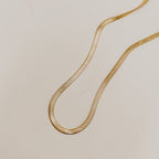 Clementine flat herringbone chain necklace in gold plated stainless steel.