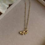 Small Heart locket open on a linen tray, showing both photo windows.