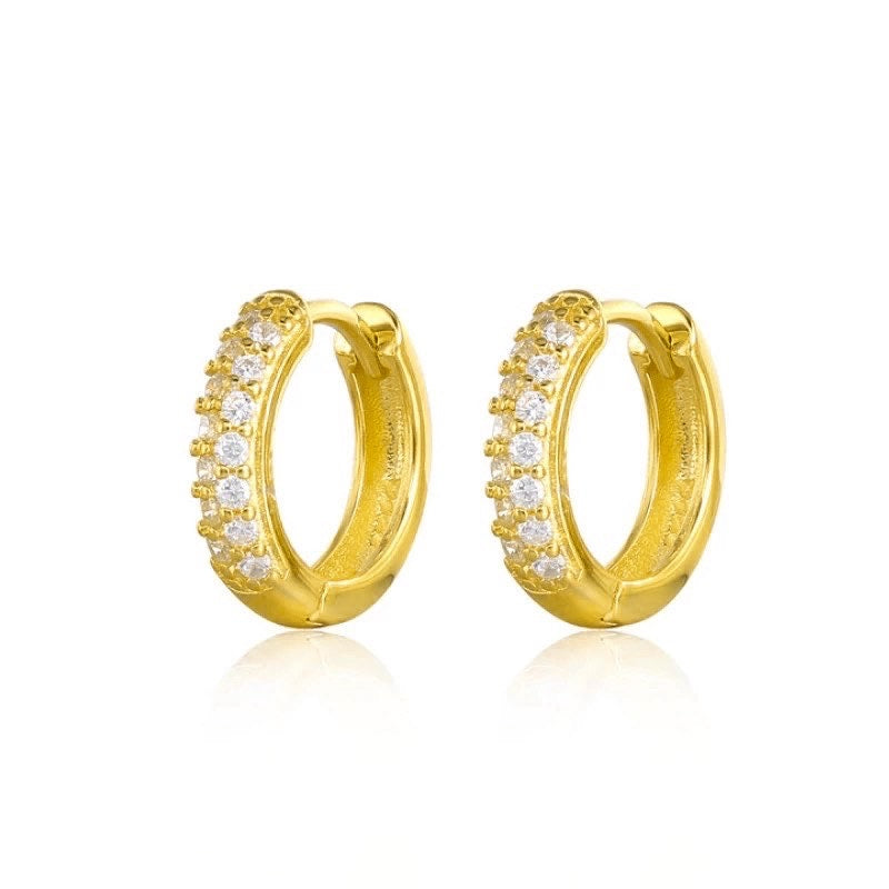 Pair of Sage huggie hoops in 18K gold vermeil set with cubic zirconia.