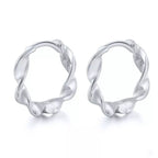 Pair of Wave huggie hoops in sterling silver with a twisted design.